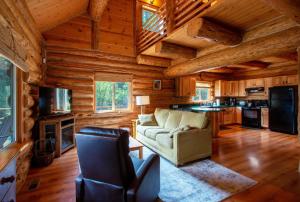 a living room in a log cabin with a couch at The Log Cabin in Stevenson