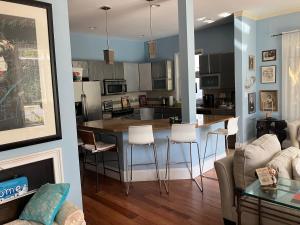 a kitchen and living room with a table and chairs at Rehoboth Beach Haven in Rehoboth Beach