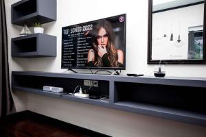 a counter in a room with a tv on a wall at Beautiful apartment in Ban Thalat Choeng Thale