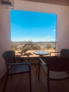 a room with a table and chairs and a large window at RIVER LuX in Veliko Gradište