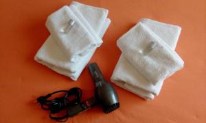 a group of towels and a hair dryer on a table at B&B Salviani in Acilia