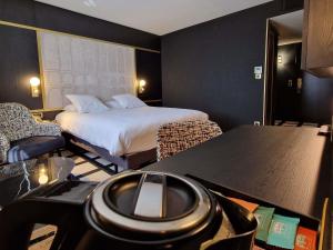 a hotel room with a bed and a desk with a camera at Mercure Orléans Centre Bords de Loire in Orléans +185 photos