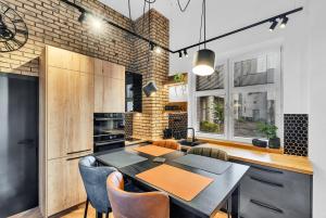 a kitchen and dining room with a table and chairs at Central Designer Loft - Modern & Chic in Staré Mesto