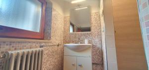 a bathroom with a sink and a mirror at Maya Suite & Garden in Sarteano