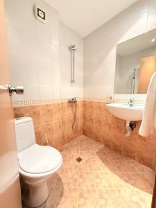 a bathroom with a toilet and a sink at Struma Hotel in Pernik