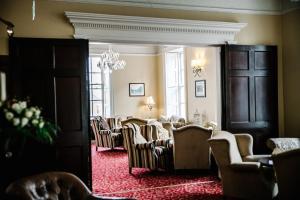 a waiting room with chairs and a chandelier at Annebrook House Hotel in Mullingar