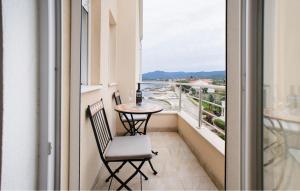 a balcony with a table and chairs and a window at Gorgeous Apartment In Sreser With House Sea View in Sreser