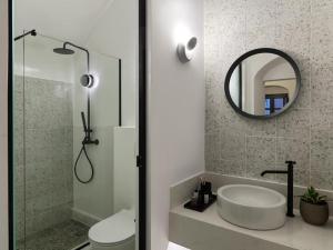 a bathroom with a toilet and a sink and a mirror at Astris Suite, Mansion Double Room, Imerovigli in Imerovigli