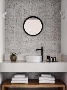 a bathroom with a sink and a mirror at Astris Suite, Mansion Double Room, Imerovigli in Imerovigli +13 photos