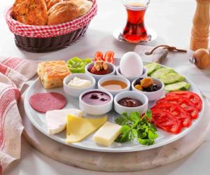 a plate of cheese and other foods on a table at Quinnova Hotel in Istanbul