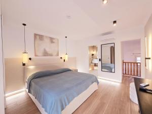 a bedroom with a bed and a living room with a table at Playas de Mallorca in Muro +15 photos