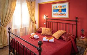 a red bedroom with a bed with red sheets and pillows at Svasso Maggiore in Pucciarelli