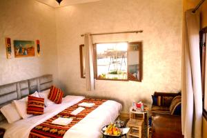 a hotel room with a bed and a window at Hotel Berber Palace Merzouga in Hassilabied +83 photos