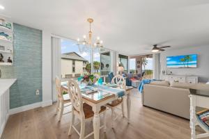 a dining room and living room with a table and chairs at Island Beach Club 210E in Sanibel