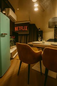 a kitchen with two chairs and a kitchen table at Glamping Špindl One&Only in Špindlerův Mlýn