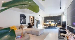 a living room with a couch and a table at Grand Spa-Francorchamps Villa - Chalourous "home sweat home" for Families, Friends & Pilots - Splendid 4-Bedroom with Home Cinema theater & pool in Spa