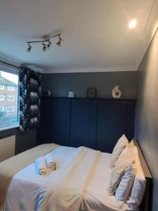 a bedroom with a bed with a woman laying on it at Lancing in Lancing