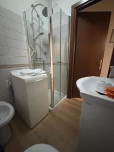 a bathroom with a shower and a toilet and a sink at Alloggio Turistico LA TORRE in Acquapendente