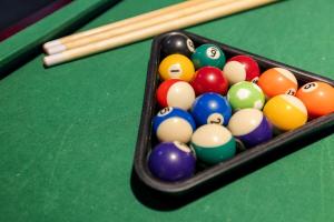 a group of billiard balls on a pool table at Red Fox Den - Luxurious home 10 guests 5 beds in Massanutten in McGaheysville