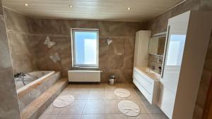 a bathroom with a tub and a sink and a window at Baobab - Villa - Jardin in Saint-Ghislain +29 photos