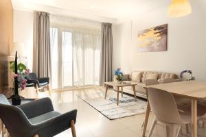 a living room with a couch and a table at Sea View Modern 2BHK Apartment with Balcony in Ras al Khaimah