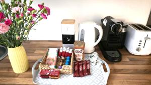 Una bandeja con comida y otros artículos sobre una mesa. en Morden Place, Free Parking & Private Entrance, en Bournemouth