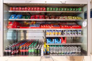 a refrigerator filled with lots of bottles of soda at Holiday Inn Express London - Dartford by IHG in Dartford +60 photos