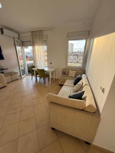 a living room with a couch and a table at Grand Bazaar BALCONY in Tirana