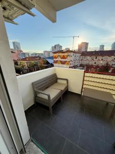 a bench on a balcony with a view of a city at Grand Bazaar BALCONY in Tirana +28 photos