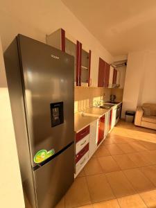 a large stainless steel refrigerator in a kitchen at Grand Bazaar BALCONY in Tirana
