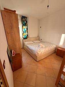 a bedroom with a bed and a window at Grand Bazaar BALCONY in Tirana