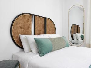 a bedroom with a bed with a mirror above it at Notia Suite, Jacuzzi, Imerovigli in Imerovigli