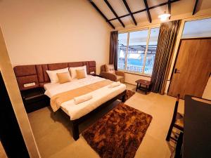 a bedroom with a bed and a large window at Vista Mare in Vagator +33 photos
