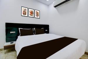 Ένα ή περισσότερα κρεβάτια σε δωμάτιο στο Hotel O DRN Palace +18 φωτογραφίες