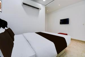 Ένα ή περισσότερα κρεβάτια σε δωμάτιο στο Hotel O DRN Palace