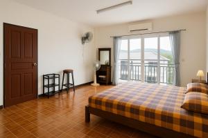 a bedroom with a bed and a large window at Rose's Roadhouse in Pai +37 photos