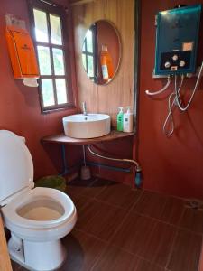 a bathroom with a white toilet and a sink at Here in chiang dao in Chiang Dao