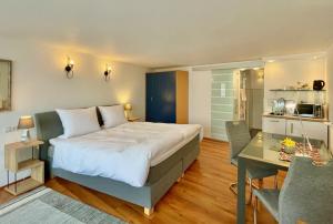 a bedroom with a large bed and a desk at Gästehaus No. 3 in Simmern
