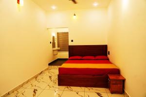 a bedroom with a bed in the corner of a room at Sravan Villa in Vagamon +3 photos