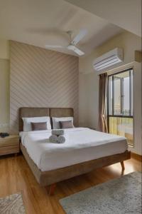 a bedroom with a large bed and a window at hotel monville in Vadodara