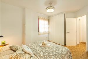 a bedroom with a bed with a towel on it at Apartment in Los Cristianos WIFI in Arona