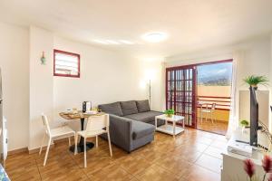 a living room with a couch and a table at Apartment in Los Cristianos WIFI in Arona