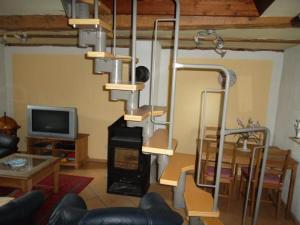 a living room with a fireplace and a chandelier at Freistehendes Ferienhaus In Ruhiger Lage in Rubitz