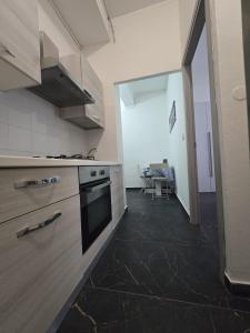 a kitchen with a sink and a stove top oven at Bilocale 40 mq con parcheggio privato in Milan