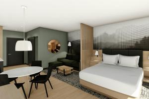 une chambre avec un lit et un salon dans l'établissement Residence Inn by Marriott Bromont, à Bromont