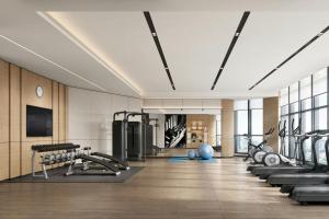 a gym with several treadmills and exercise machines at Fairfield by Marriott Hangzhou Future Sci-tech City in Hangzhou