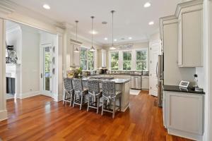 a kitchen with a large island with bar stools at HH2482: 2482 High Hammock Road in Seabrook Island