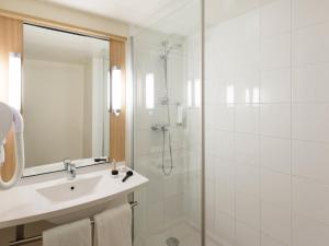 a white bathroom with a sink and a shower at ibis Metz Centre Gare in Metz