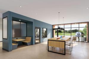 a dining room with a blue wall and a table and chairs at StudioRes Jacksonville Orange Park in Jacksonville