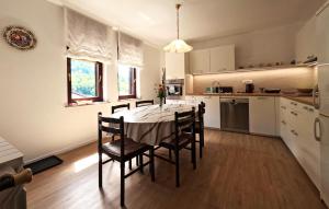 a kitchen with a table and chairs in a room at Apartma Mika in Most na Soči